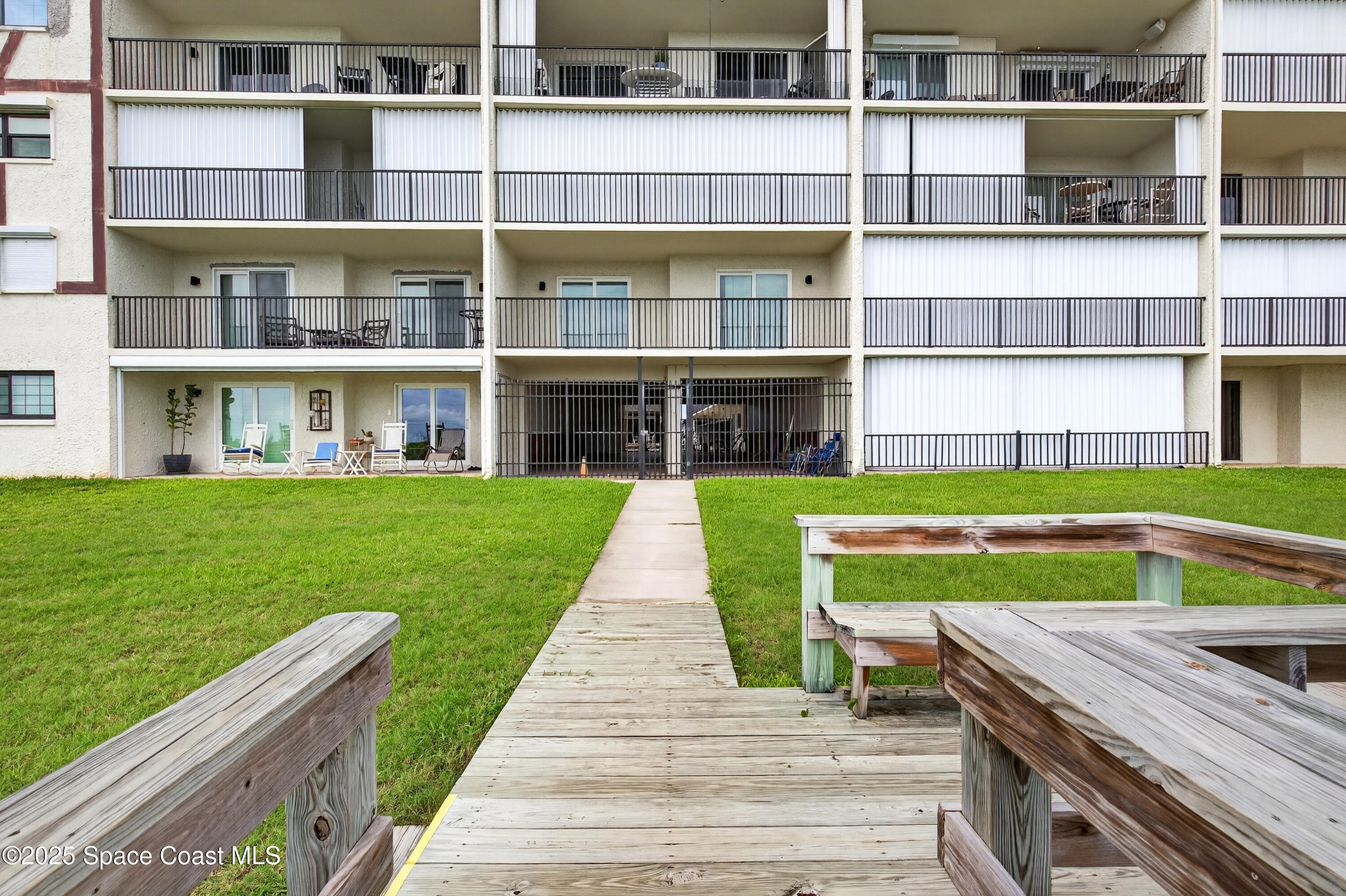 383 North Atlantic Avenue, Unit 105 Cocoa Beach, FL 32931 - Photo 54 of 67 a view of building with yard