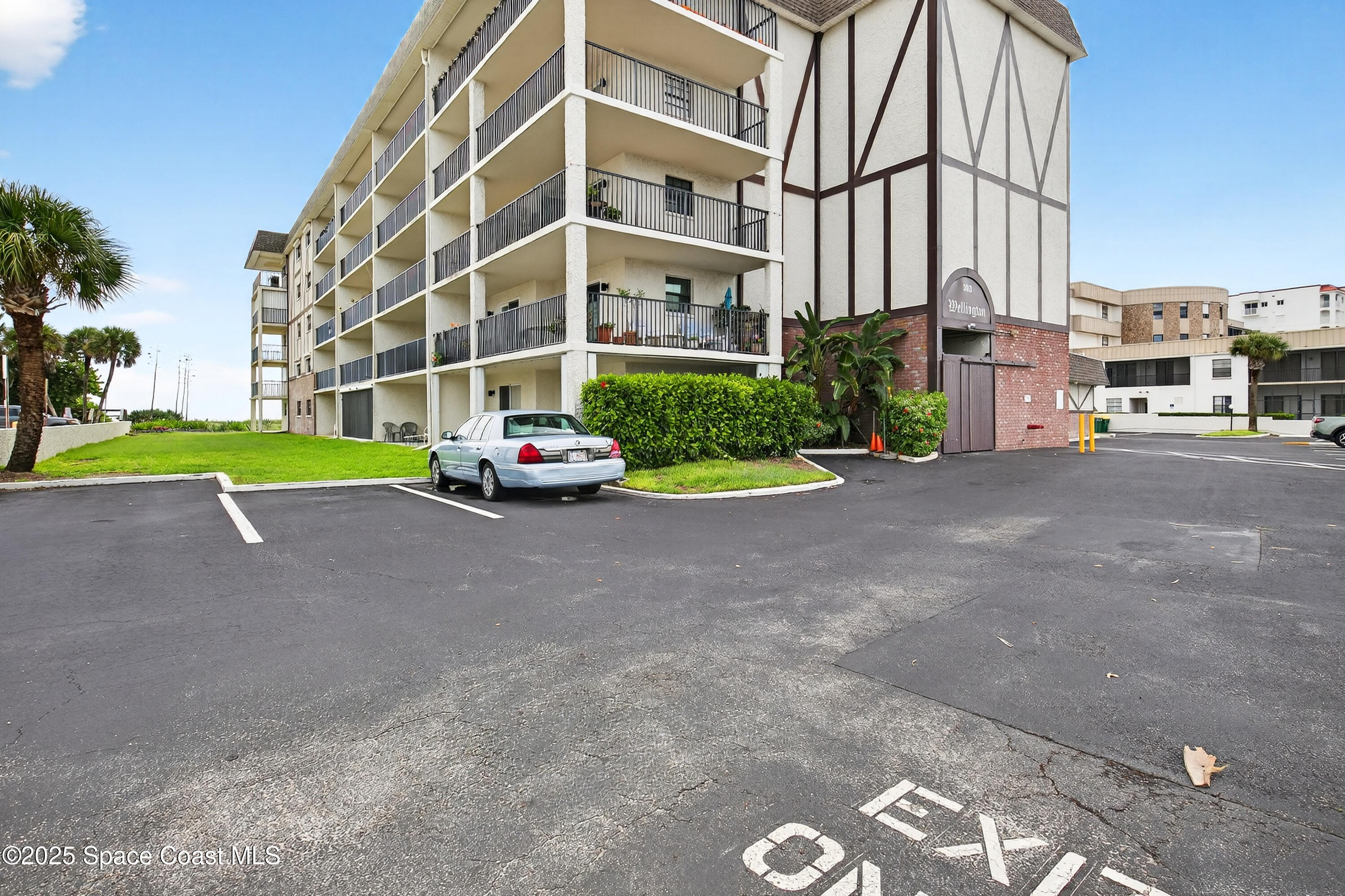 383 North Atlantic Avenue, Unit 105 Cocoa Beach, FL 32931 - Photo 60 of 67 a cars parked in front of a building