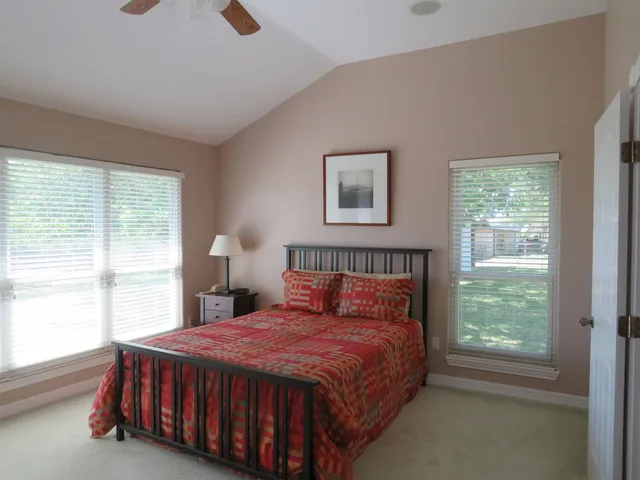 a bedroom with a bed lamp and window