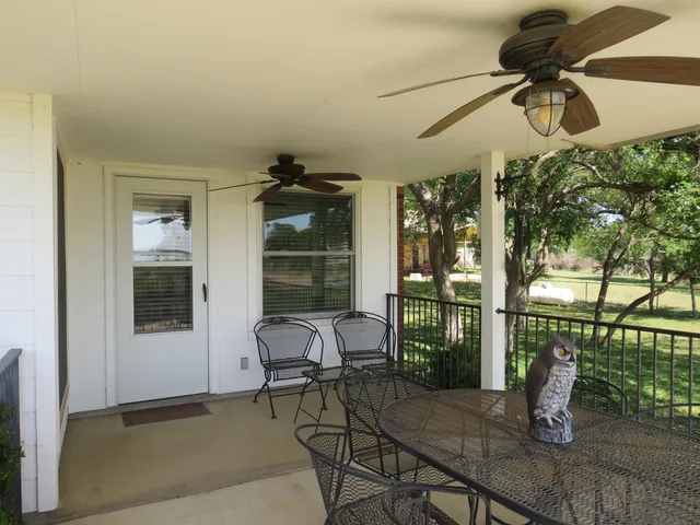 a view of a house with a big yard and a large tree