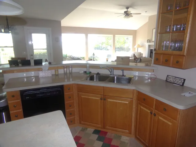 a kitchen with stainless steel appliances granite countertop a sink and a stove