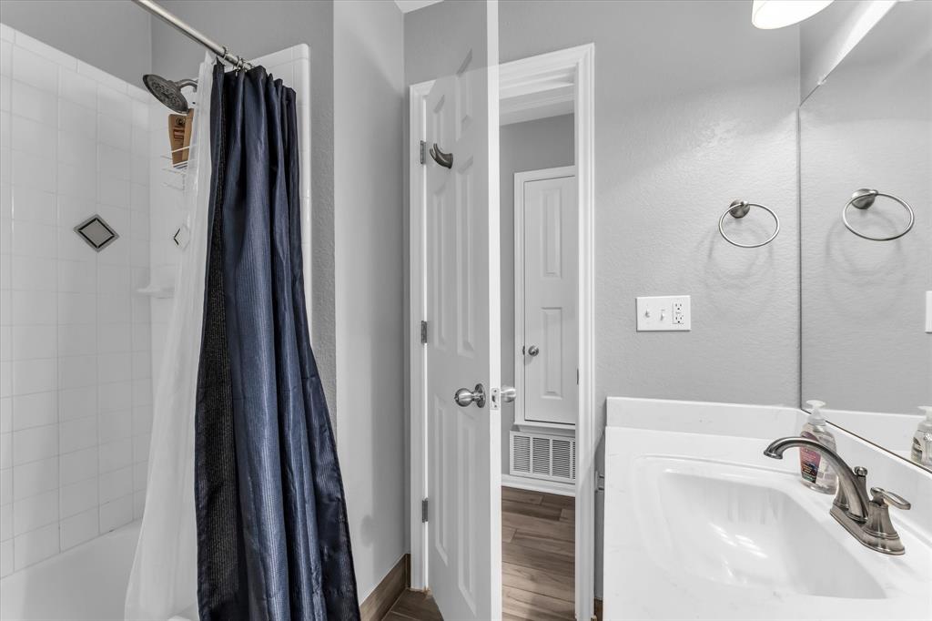 7 Market Loop Morgan's Point Resort, TX 76513 - Photo 20 of 31 Bathroom featuring a white vanity with a sink, brushed nickel faucet, faux wood-finish flooring, and light gray walls