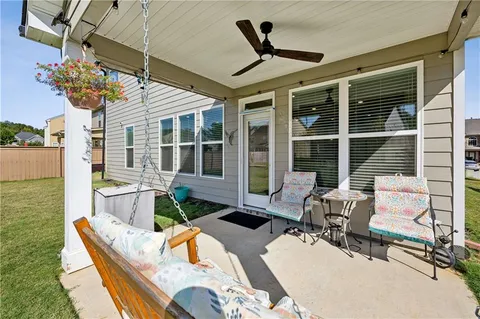 a view of a patio with table and chairs potted plants with wooden floor