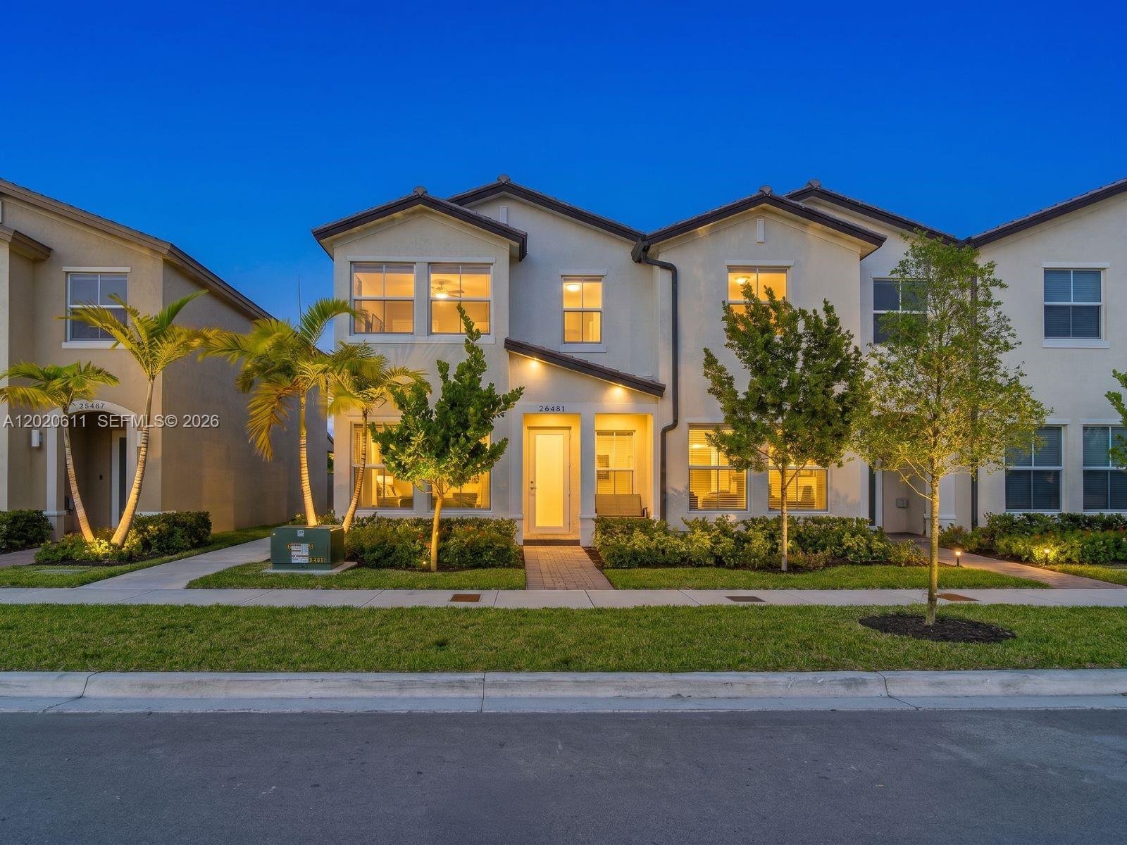 26455 Southwest 148th Avenue Homestead, FL 33032 - Photo 1 of 35 a front view of a house with a yard