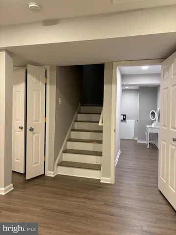 a view of a livingroom with wooden floor and stairs