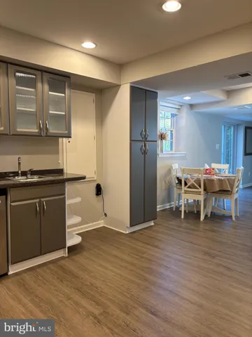 a kitchen with stainless steel appliances kitchen island granite countertop a refrigerator and a stove top oven