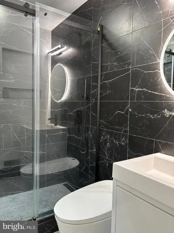 a bathroom with a toilet a sink and shower
