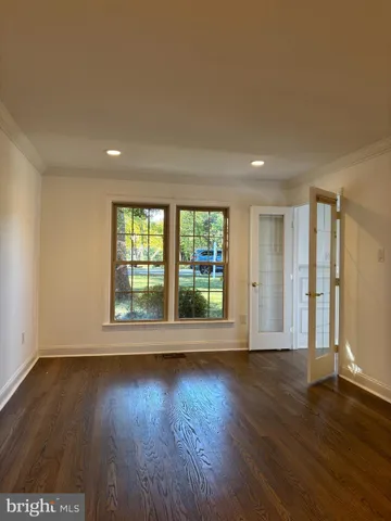 a view of wooden floor and windows in a room