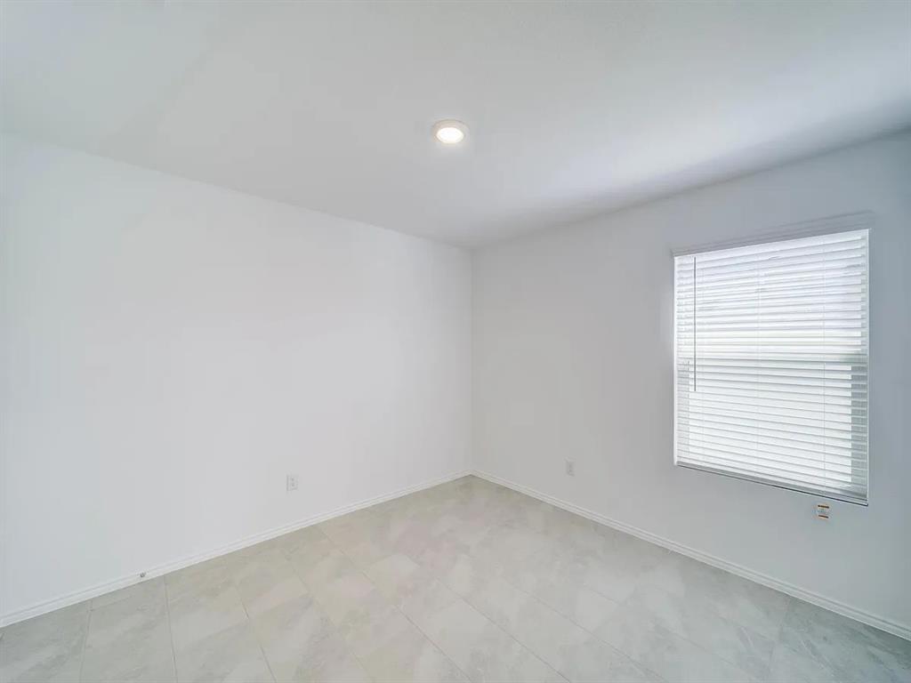 352 Sun Bluff Road Fort Worth, TX 76052 - Photo 22 of 33 Spacious room featuring neutral white walls, recessed ceiling lighting, light-toned tile flooring, and a window with blinds