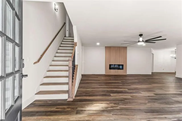 a view of entryway and hall with wooden floor