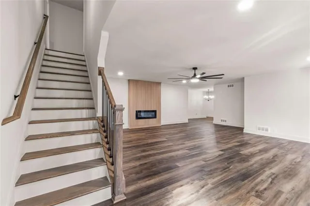 an empty space with wooden floor and staircase