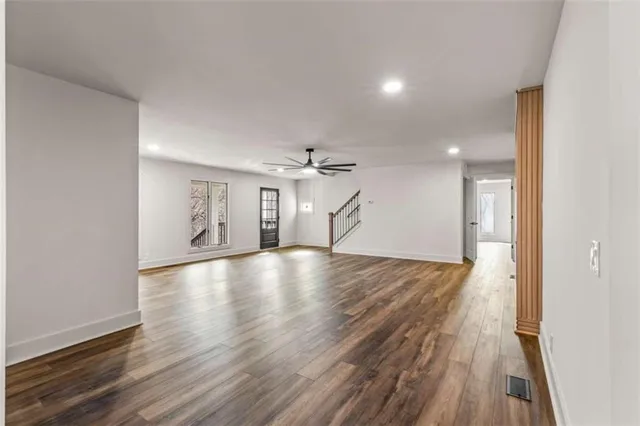 a view of empty room with wooden floor