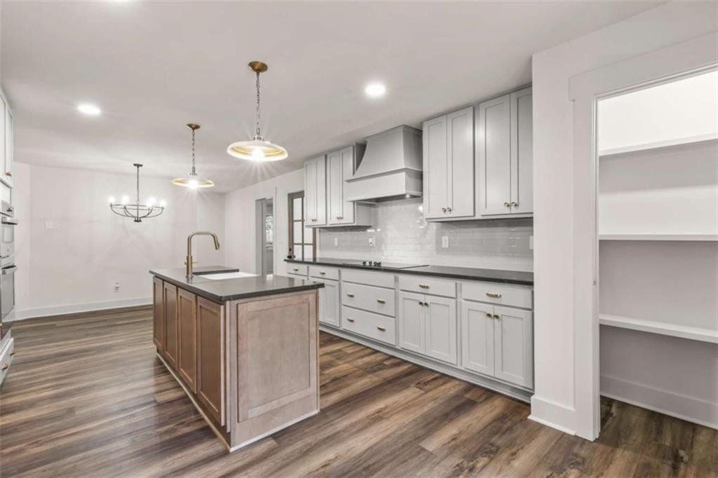 7448 Berea Road Winston, GA 30187 - Photo 20 of 43 a kitchen with stainless steel appliances granite countertop a sink a stove and a wooden floors