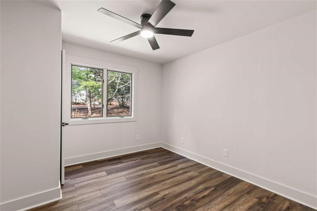 7448 Berea Road Winston, GA 30187 - Photo 22 of 43 an empty room with wooden floor and windows