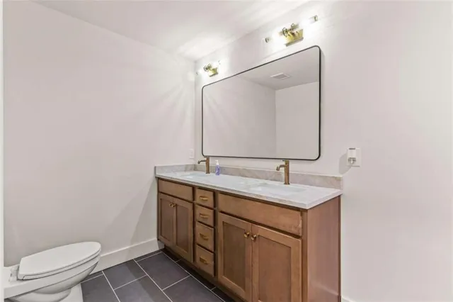a bathroom with a toilet sink and mirror