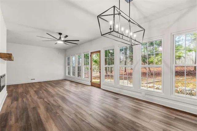a view of a livingroom with wooden floor and a ceiling fan