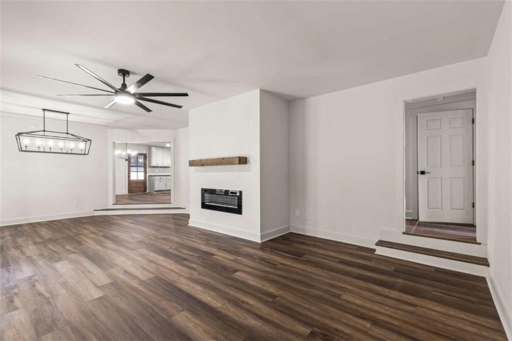 7448 Berea Road Winston, GA 30187 - Photo 28 of 43 a view of a livingroom with wooden floor and a ceiling fan