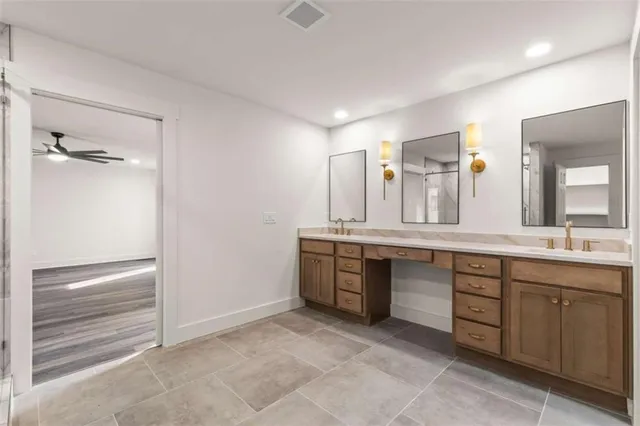 a spacious bathroom with a granite countertop sink and a mirror