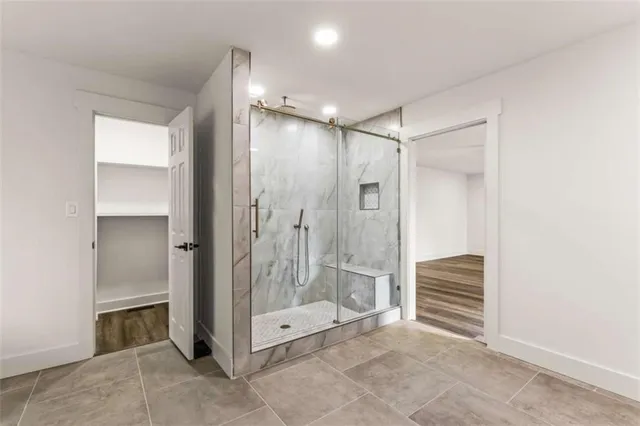 a bathroom with a shower and a glass door