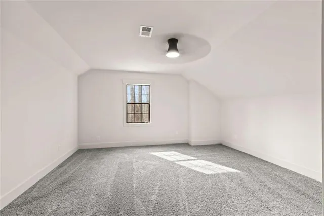 an empty room with a empty space and windows