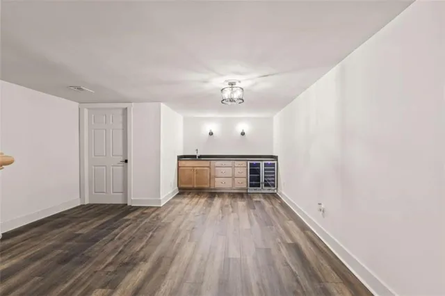 a view of a room with wooden floors and ceiling fan