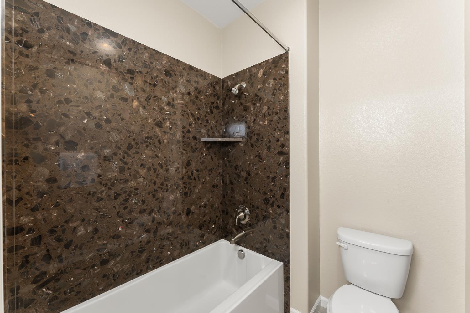 5453 Mossy Stone Way Rancho Cordova, CA 95742 - Photo 50 of 81 a bathroom with a toilet and a shower