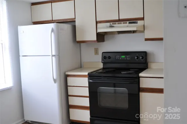 a kitchen with stainless steel appliances a refrigerator and a stove