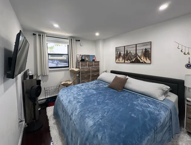 a bed room with a bed window and mirror