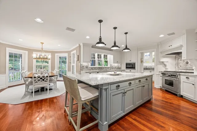 a large kitchen with kitchen island a large island in the center