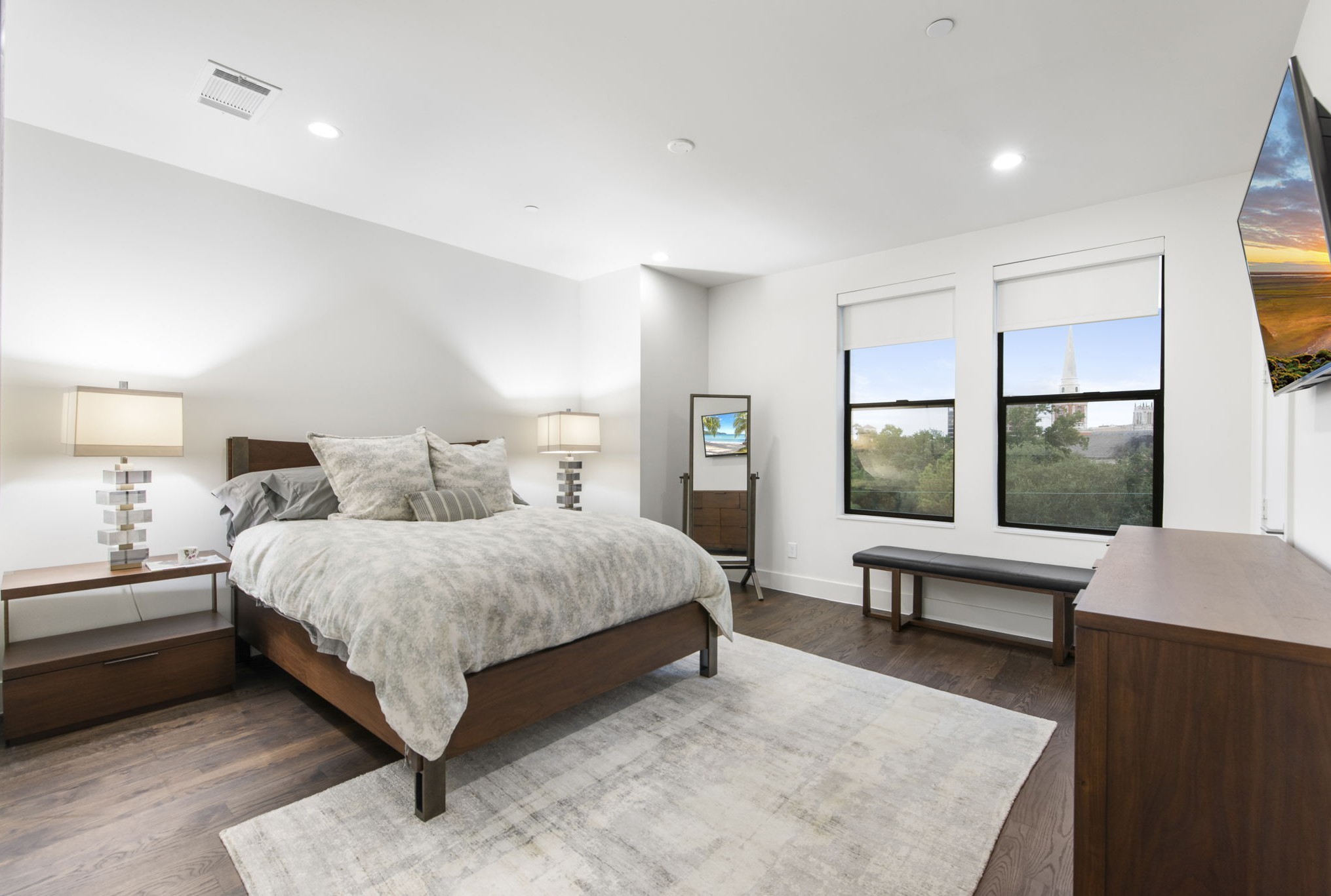 205 Portland Street Houston, TX 77006 - Photo 29 of 36 a spacious bedroom with a bed and large windows