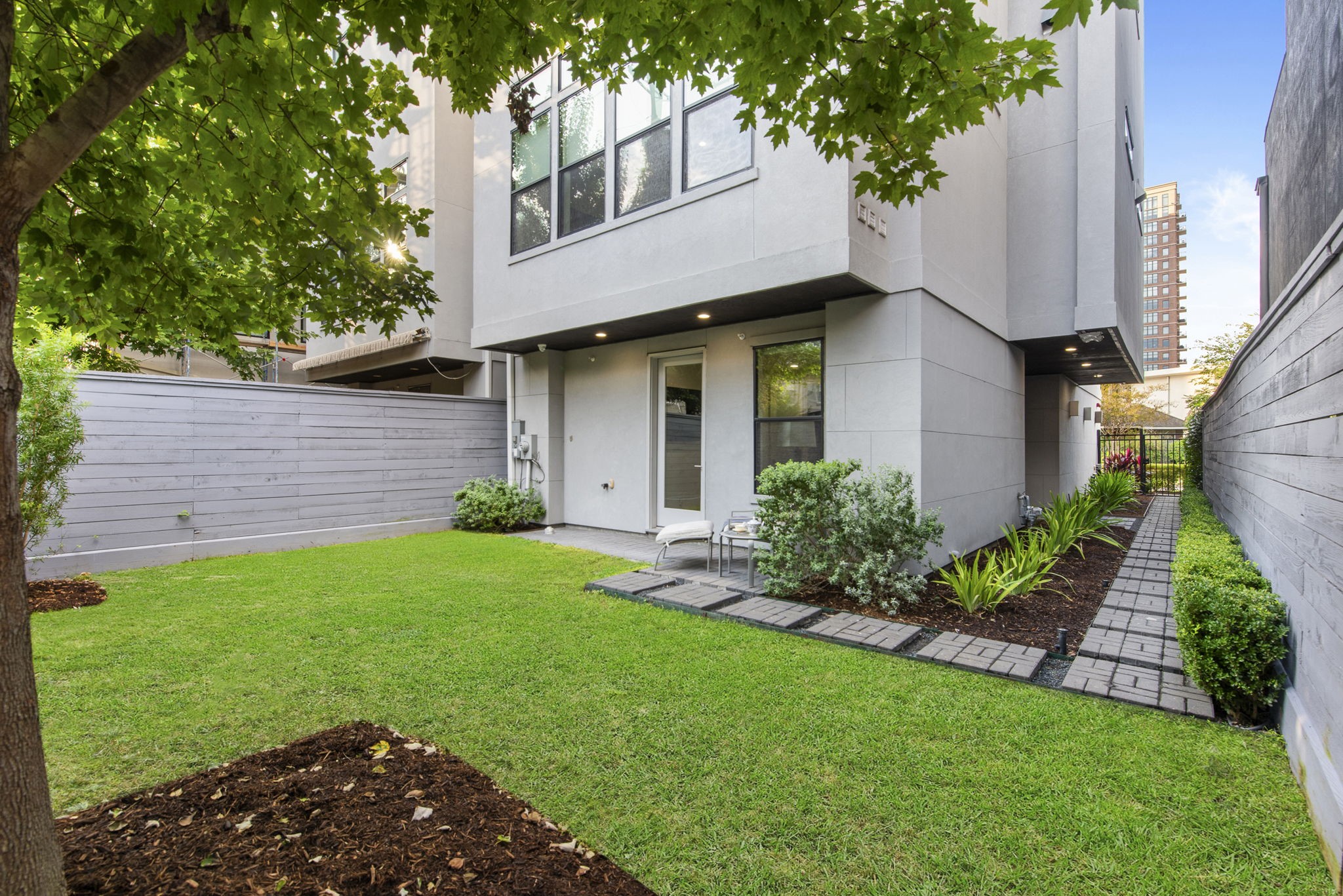 205 Portland Street Houston, TX 77006 - Photo 34 of 36 a view of a house with a yard and a large tree