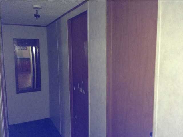 6136 Buckward Road Baker, FL 32531 - Photo 22 of 28 a view of a hallway with wooden floor