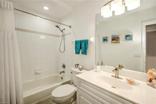 a bedroom with a bed and a flat tv screen on dresser