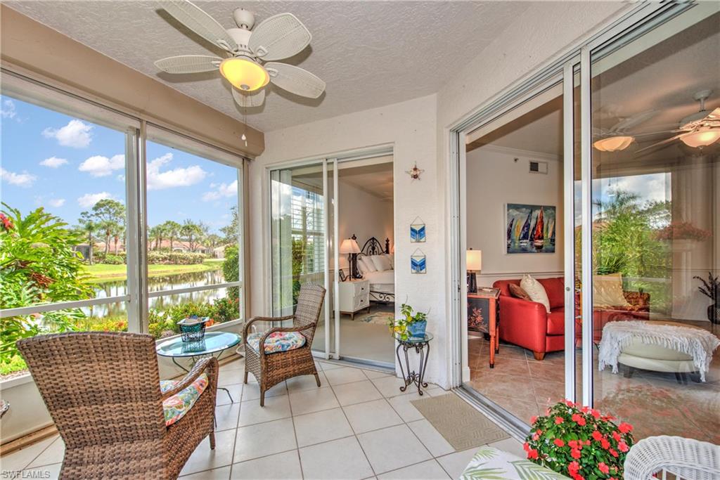 8385 Whisper Trace Way, Unit N104 Naples, FL 34114 - Photo 13 of 16 a living room filled with furniture and chandelier