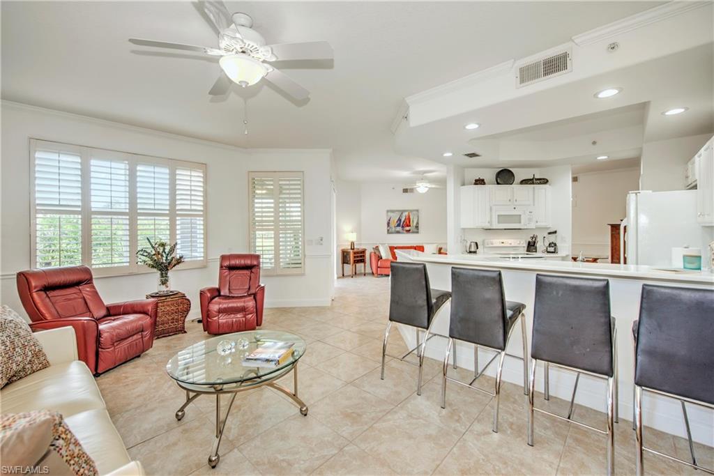 8385 Whisper Trace Way, Unit N104 Naples, FL 34114 - Photo 5 of 16 a living room with furniture and kitchen view