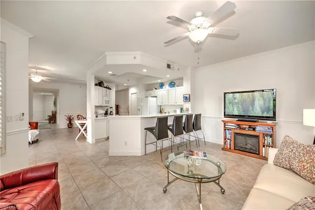 a living room with furniture and kitchen view