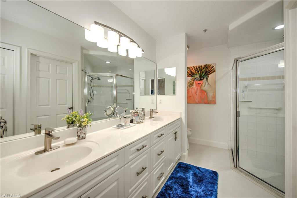 8385 Whisper Trace Way, Unit N104 Naples, FL 34114 - Photo 9 of 16 a bathroom with a double vanity sink mirror and double