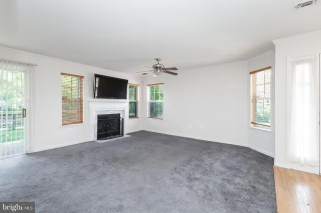 a view of a livingroom with a fireplace and window