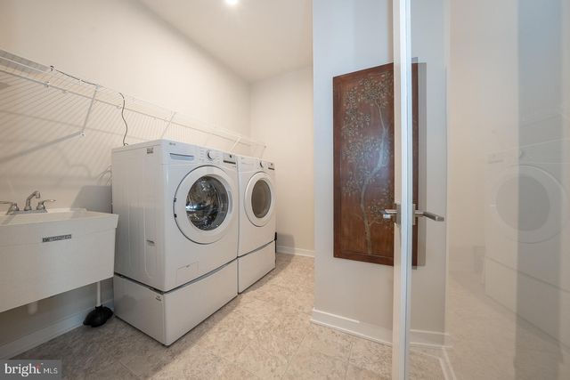 a kitchen with a sink a stove a refrigerator and cabinets