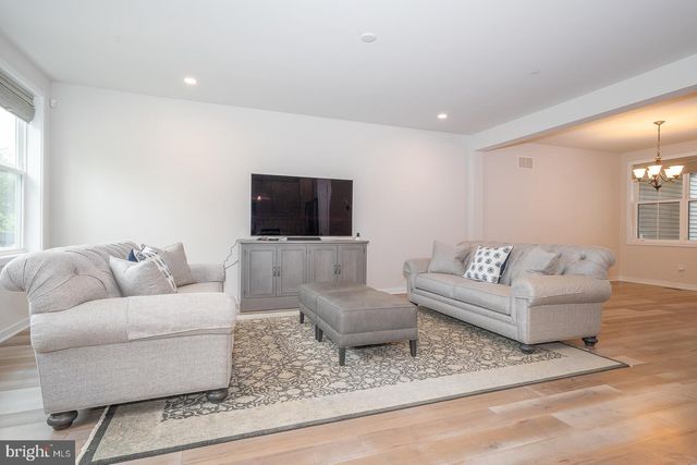 a view of a hallway with wooden floor and entryway