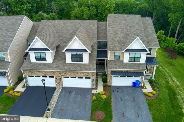 an aerial view of a house with swimming pool and sitting area
