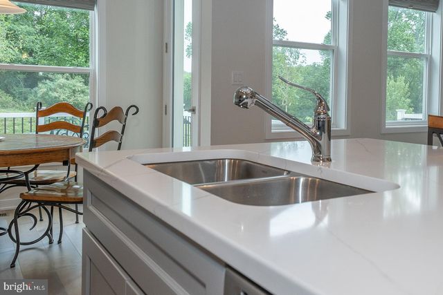 a bedroom with a large bed and a chandelier fan