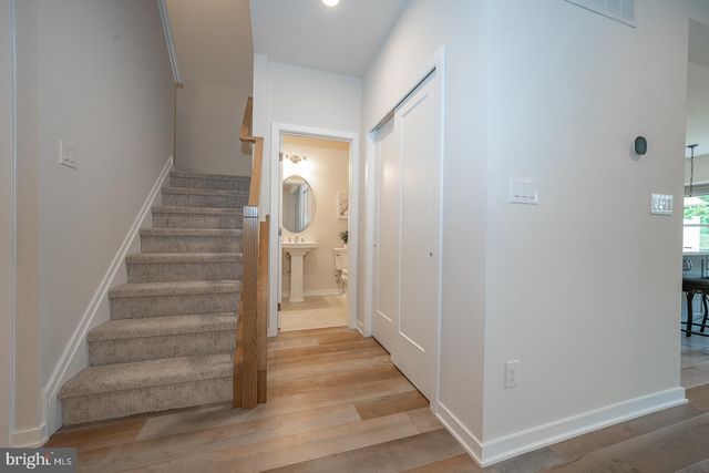 a bathroom with a double vanity sink toilet and a mirror