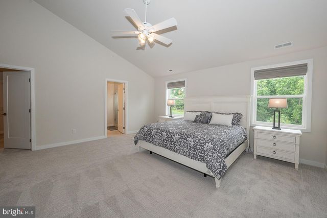 a view of empty room with wooden floor and windows