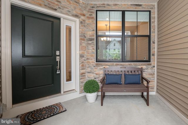 a view of a dining room with furniture a chandelier and wooden floor