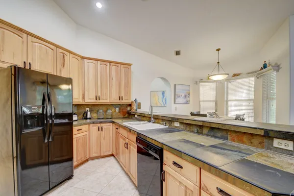 a kitchen with a sink stove and refrigerator