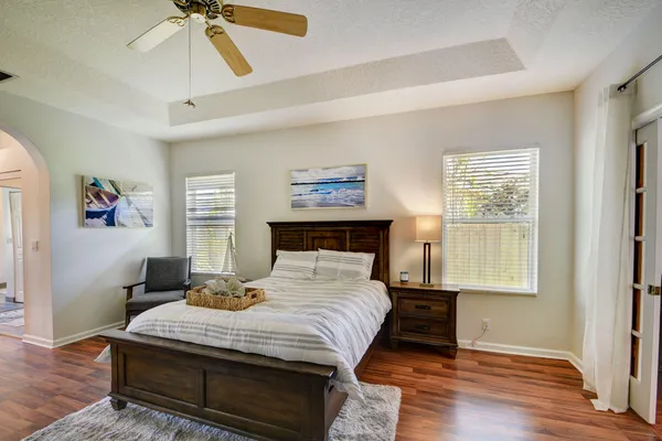 a bedroom with a bed and wooden floor