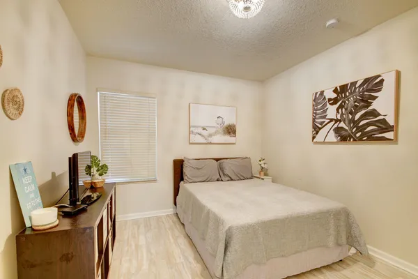 a bedroom with a bed and a desk