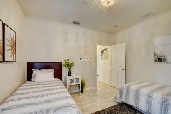 a bedroom with a bed and wooden floor