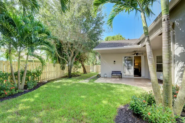 a view of a chair and table in backyard of the house